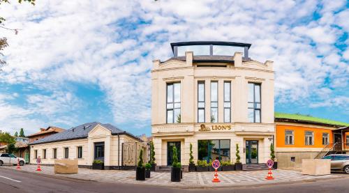 a white building with a tower on top of it at Lion's Hotel in Chişinău