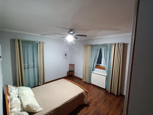 a bedroom with a bed and a ceiling fan at Casa da rosinha - Minho, Portugal in Arcos de Valdevez