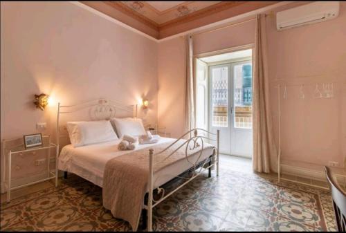 a bedroom with a bed and a large window at A Casa ra Signurina in Modica