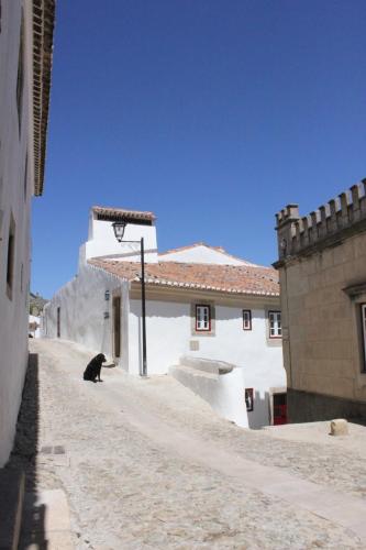 a black bear sitting on the side of a building at Estalagem de Marvão in Marvão