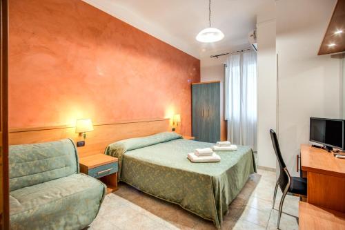 Pokój hotelowy z 2 łóżkami i krzesłem w obiekcie Hotel Millerose w Rzymie