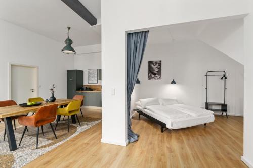 a bedroom with a bed and a table and chairs at Loft-Appartements mit Terrasse in Bremen