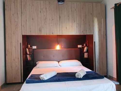 a bedroom with a large bed with two towels on it at Studio Apartment Residenza del Sole in La Maddalena