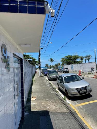 Une rangée de voitures garées sur le côté d'une rue dans l'établissement Apartamento Vista Mar - Marina, à Praia Grande