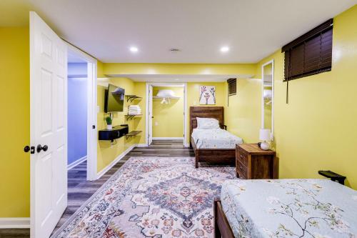 a bedroom with two beds and yellow walls at Lovely 2 Bedroom, 2 Bath Unit in West Alexandria. in Alexandria