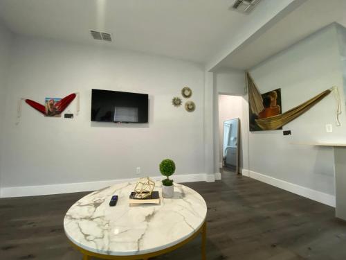 a living room with a marble table and a tv at Bella Breeze in Sanford