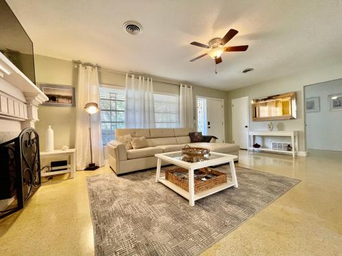 a living room with a couch and a ceiling fan at Rowena House 2bd Den 2bth Heated Pool Near Siesta Key in Sarasota