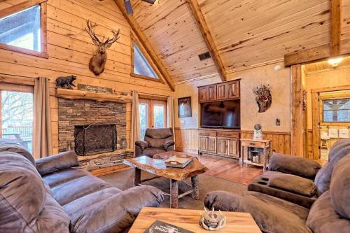 a living room with couches and a fireplace at Ruby River Lodge in Ellijay