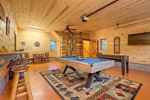 a room with a pool table in a cabin at Ruby River Lodge in Ellijay