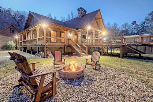 a log cabin with a fire pit in front of it at Ruby River Lodge in Ellijay