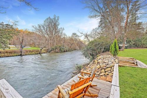 a wooden bridge over a river with a rock wall at Ruby River Lodge in Ellijay