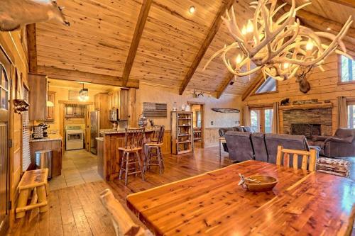 a dining room and living room with a wooden ceiling at Ruby River Lodge in Ellijay