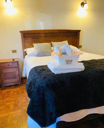 a hotel room with a bed with towels on it at Cabaña en Puerto Natales in Puerto Natales