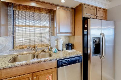 a kitchen with a stainless steel refrigerator and a sink at Beachside One 4023 in Destin