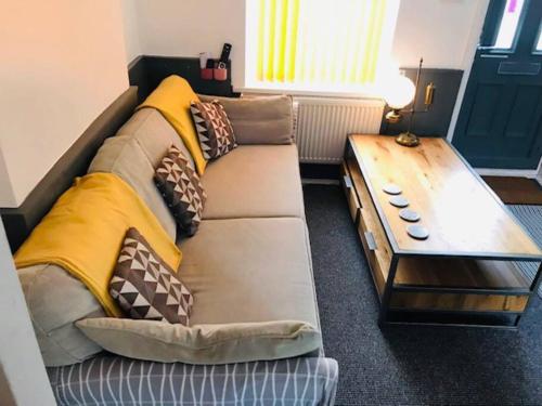 a couch with pillows on it in a room at Bikers Grove Cottage in Troed-y-rhiw