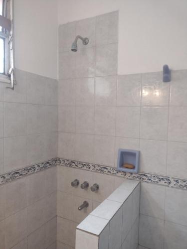 a white bathroom with a shower with a sink at Casa en Santa Rosa in Santa Rosa