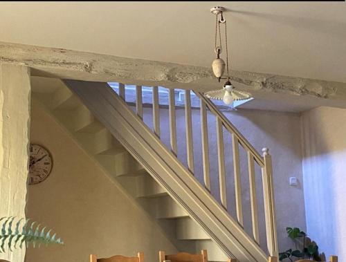 a stairway with a white rail and a window at chambre familiale 4 pers SDB partagée sans TV in Le Saint