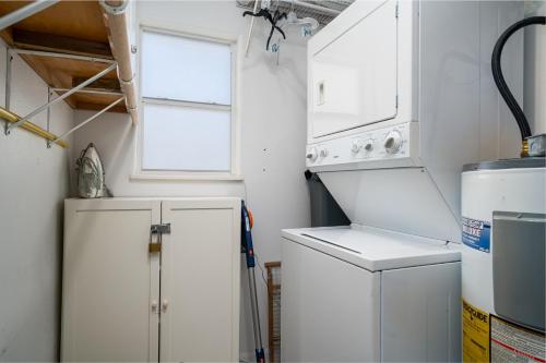 a small kitchen with a refrigerator and a window at Lunasea Haven in Rockport