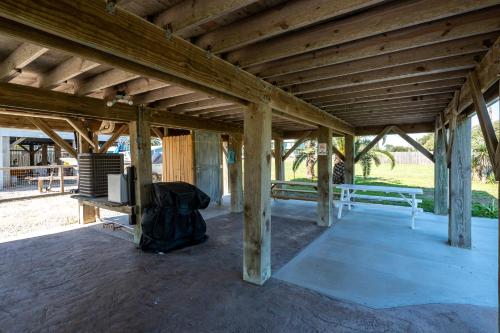 a wooden pavilion with a television and a backpack at Lunasea Haven in Rockport