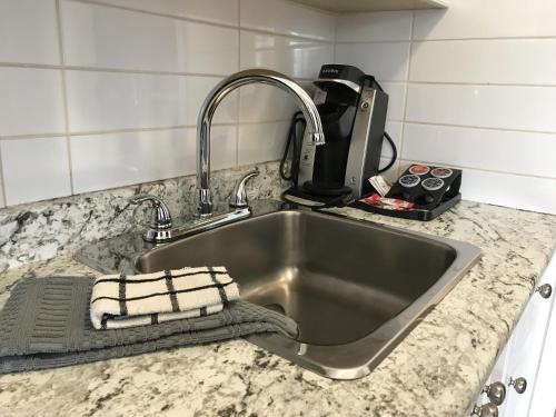 a kitchen counter with a sink and a mixer at Duncan Motel in Duncan
