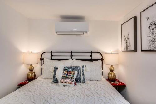 a bedroom with a bed with pillows and two lamps at JT Cottage in Yucca Valley