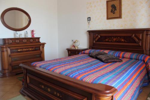 a bedroom with a bed with a mirror and a dresser at B&B Villa Angela in San Salvo