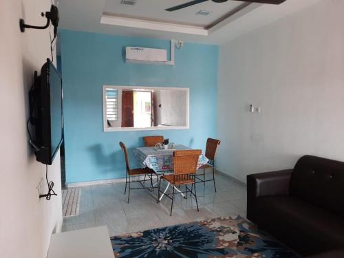 a living room with a table and chairs at Jerai Geopark Cottage 2bedrooms Pulau Bidan in Yan