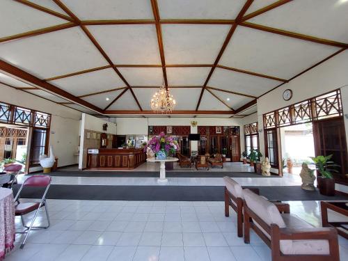 a large living room with a lobby with a chandelier at Puri Merbabu Asri 