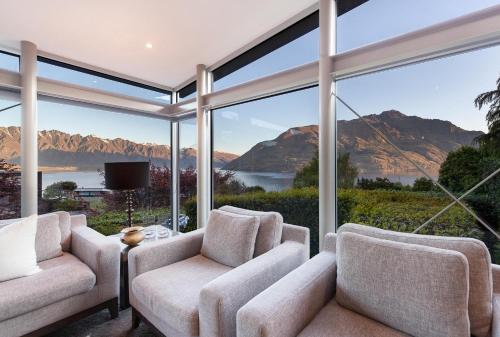 a living room with a view of the mountains at Remarkable Escape for 8 in Queenstown