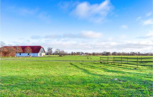 a field with a barn and a fence at Lovely Home In Skivarp With Wifi in Skivarp