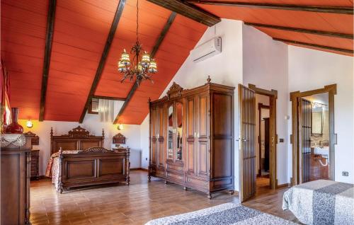 a bedroom with a bed and a wooden ceiling at 7 Bedroom Awesome Home In Lucena in Lucena