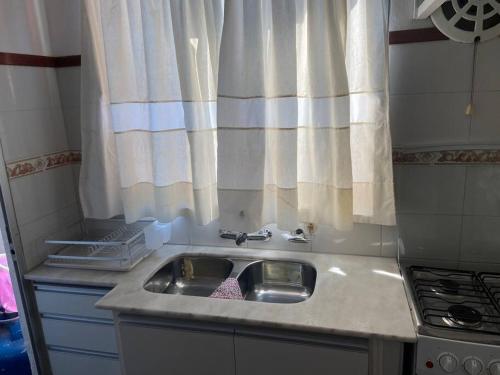 a small kitchen with a sink and a window at Casa Nostrum Priceless View Central Location 3BR 3BA in Punta del Este