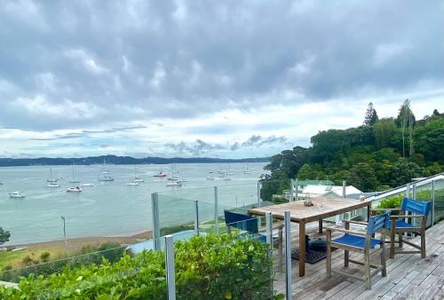 a balcony with a table and chairs and boats in the water at Wharf View in Russell