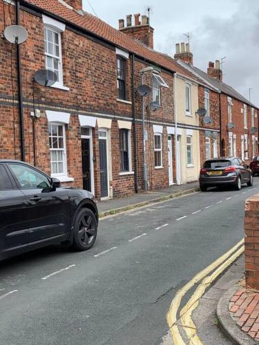 a black car parked on the side of a street at No6 - Beverley - Elegant Townhouse - Central location in Beverley