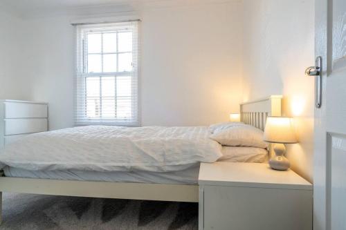 a white bedroom with a bed and a window at No6 - Beverley - Elegant Townhouse - Central location in Beverley