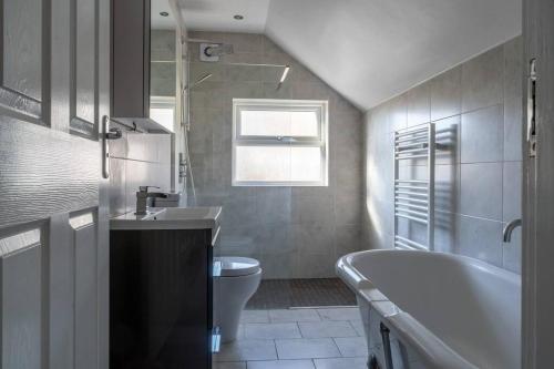 a bathroom with a sink and a tub and a toilet at No6 - Beverley - Elegant Townhouse - Central location in Beverley