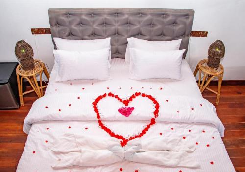 a bed with a heart made out of red confetti at Awesome Place in Ella