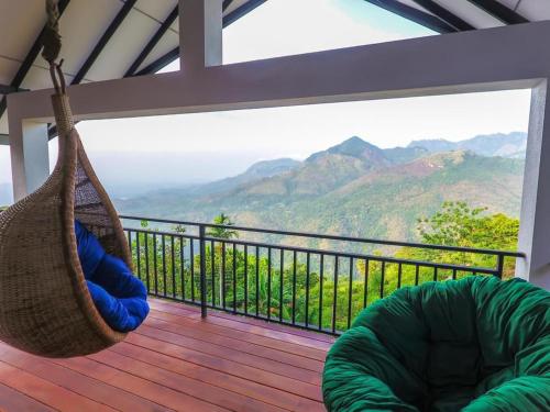 a hammock on a deck with a view of mountains at Awesome Place in Ella