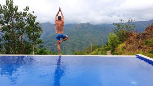 a man doing a trick in the air on top of a swimming pool at Awesome Place in Ella