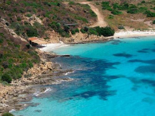 an aerial view of a beach with blue water at Hotel Ariadimari in Valledoria