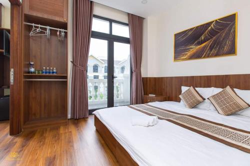 a bedroom with a large bed and a large window at Golden Lotus Homestay Phú Quốc in Phu Quoc