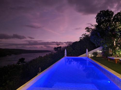 a swimming pool with a view of the water at Butterfly Villas Nusa Ceningan in Nusa Lembongan