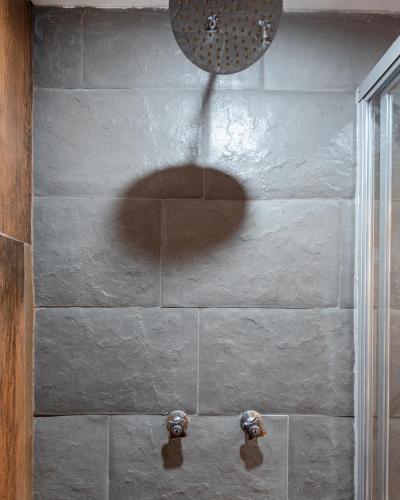 a shadow of a person in a shower at Town Center Apartments in Urubamba