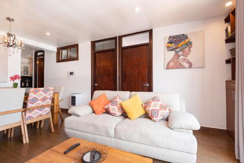 a living room with a couch and a table at Town Center Apartments in Urubamba