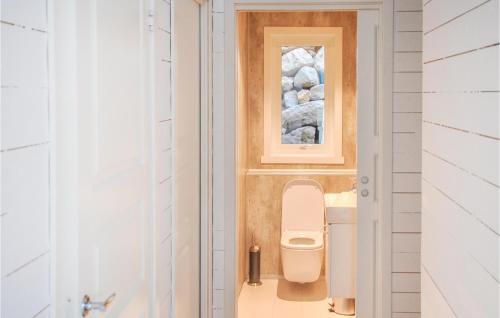 a bathroom with a toilet and a mirror at Nice Home In Ornes With House Sea View in Ornes