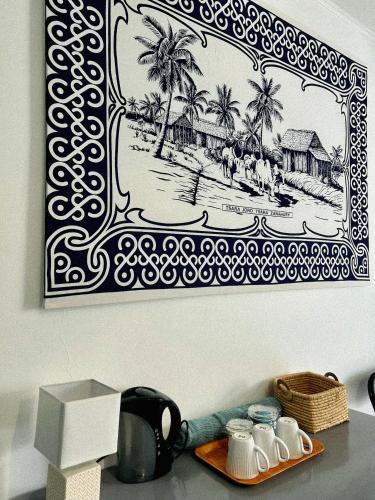a picture of a beach with palm trees on a wall at Villa Kazabona Saint-Pierre centre - Chambres d'hôte in Saint-Pierre