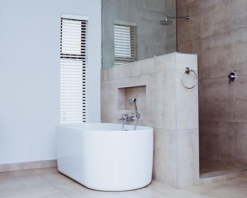 a bathroom with a white sink and a shower at Villa Gracia Guesthouse in Klerksdorp