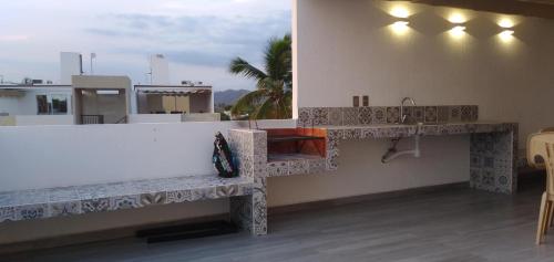 a bathroom with a counter and a sink on a building at Penthouse junto al mar in Manzanillo