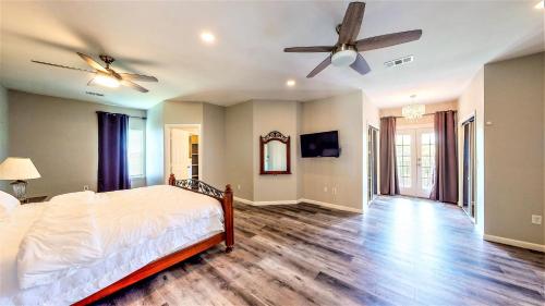 a bedroom with a bed and a ceiling fan at Lions Meadow in Dickinson