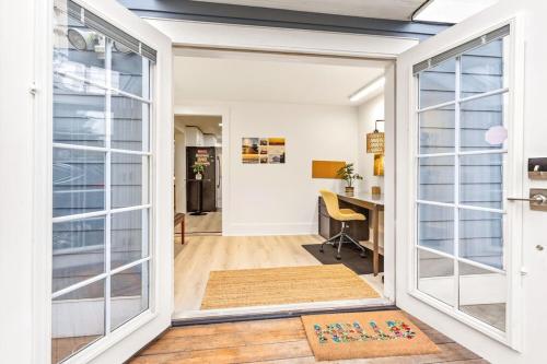 an open door leading into a home office with a desk at NEW: Bright, Peaceful Retreat in Iconic Seattle Neighborhood in Seattle